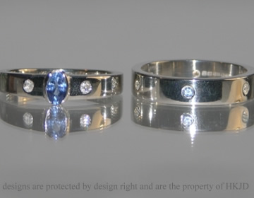 Bespoke platinum wedding ring with blue sapphires and diamonds