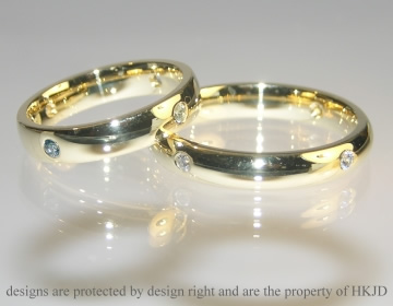 Pair of 18ct yellow gold wedding rings with birthstones