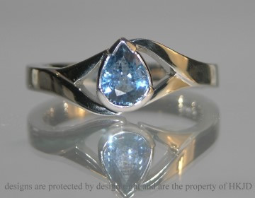 Platinum engagement ring with a pear shaped sapphire