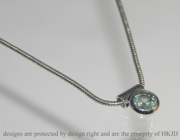 9ct white gold pendant with a 0.39ct brilliant cut green sapphire on a snake chain 