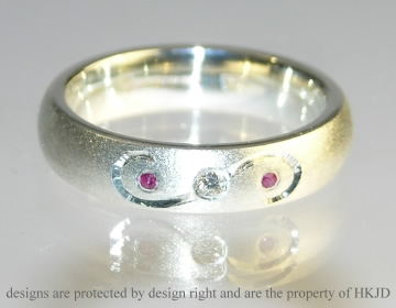 Bespoke 9ct white gold eternity ring with diamond and rubies