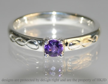 Sterling silver dress ring incorpoarating 0.23cts chequerboard cut amethyst with engraved detailing. 