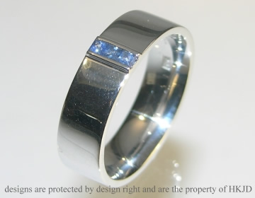 Rhodium plated 9ct white gold ring with channel set mid blue sapphires