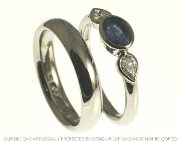 Platinum engagement ring with blue sapphire and pear shaped diamonds 