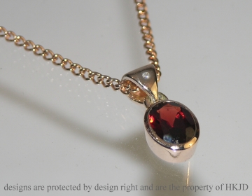 Bespoke all around set 9ct rose gold pendant incorporating customers own oval cut 1.45ct garnet.