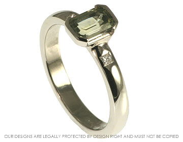 Platinum emerald cut 0.87ct green sapphire engagement ring with two princess cut 1.5mm diamonds