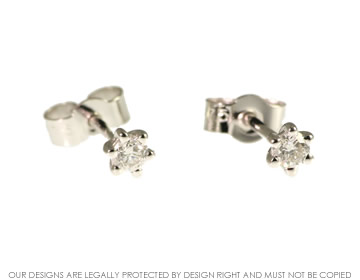 9ct white gold pendant with a brilliant cut diamond and 9ct white gold  diamond earrings. 