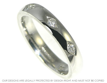 Platinum eternity ring with three grain set white diamonds