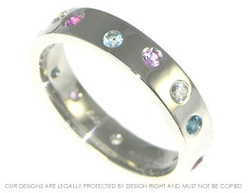 Bespoke platinum eternity ring with sapphire, topaz and diamond.