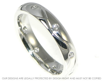 Bespoke 18ct white gold and diamond eternity ring with an engraved wave.