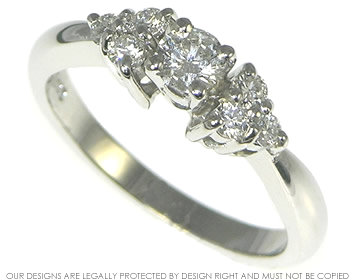 Platinum cluster engagement ring with 0.22ct central diamond.