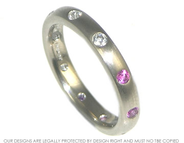 18ct White gold eternity ring with diamonds on one side and pink sapphires on the other