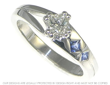 18ct white gold engagement ring with a diamond and blue sapphires.  