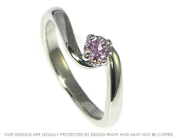 Platinum twist engagement ring with 0.25ct pink heat-treated diamond