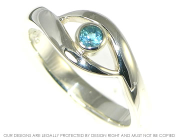 White gold and blue topaz engagement ring inspired by an eye.