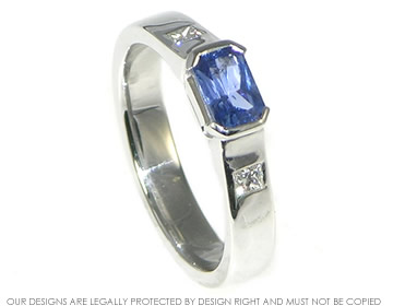 Bespoke white gold engagement ring with a sapphire and diamonds