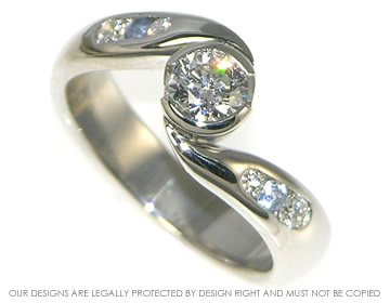 Platinum 0.47ct diamond twist style engagment ring with channel set diamonds and sapphires