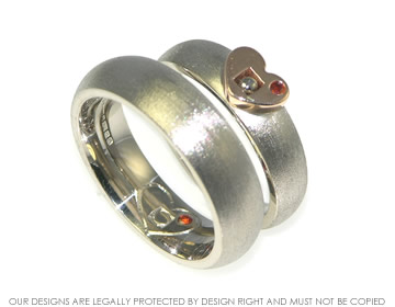 Pair of matching 9ct rose and white gold wedding bands with garnets. 