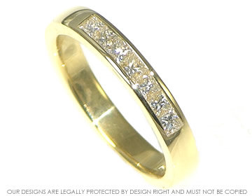 18ct yellow gold eternity ring with seven channel set diamonds.