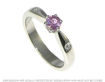 Platinum engagement ring with pink sapphire and two diamonds.