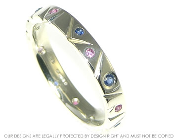 White gold meadow inspired eternity ring with pink and blue sapphires