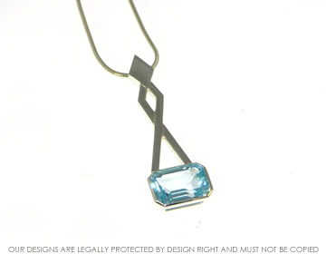 Bespoke 9ct white gold drop pendant with emerald cut sky blue Topaz