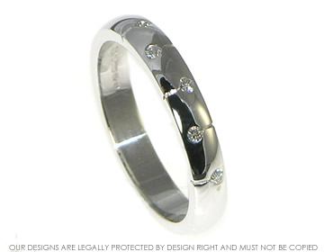 Modern white gold eternity ring with 5 brilliant cut H SI white diamonds. 