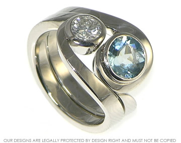 Bespoke pair of palladium twist rings with aquamarine and diamond.