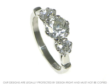 Platinum engagement ring with three brilliant cut diamonds.