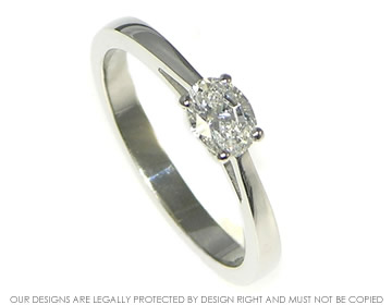 Delicate platinum and 0.46ct oval diamond engagement ring.