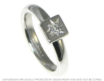 White gold diamond solitaire with star set brilliant cut diamond.