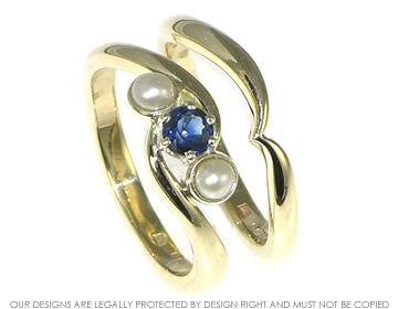 Twist Engagement ring with a blue sapphire and two pearls.