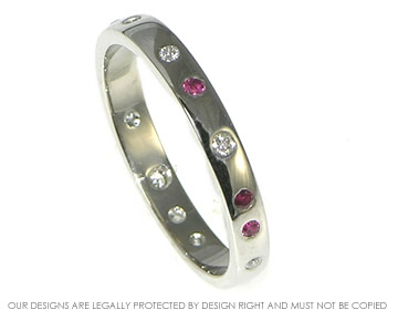 Bespoke platinum wedding ring with rubies and diamonds.