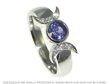 Platinum engagement ring with a sapphire and diamonds in cresent shape.