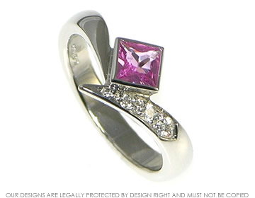 Platinum engagement ring with a princess cut pink sapphire and diamonds. 