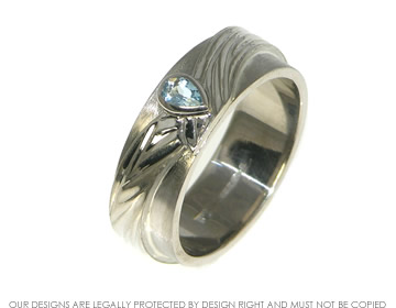 A wedding ring with a turban inspired design and engraved detail