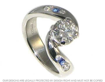 Twist style platinum diamond and sapphire engagement ring.