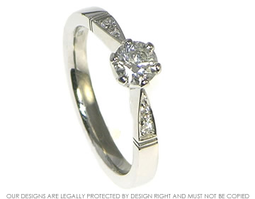 Edwardian inspired 0.47cts central diamond platinum engagement ring with shoulder diamonds.