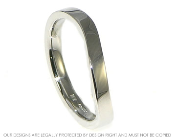 Platinum gently curved wedding band with a  polished finish.