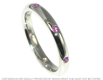 Platinum and pink sapphire engagement ring.


