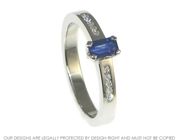 Bespoke platinum 0.39ct deep blue sapphire engagement ring, with ten H SI diamonds totaling 0.08cts.

