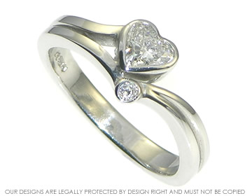 Asymmetrical platinum engagement ring with 0.40cts HSI heart shaped diamond and 2mm round diamond