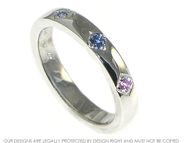 Bespoke 9ct white gold eternity ring with grain set pink and blue sapphires.