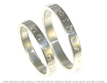 A pair of Sterling silver engraved ring polsihed rings. 