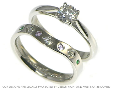 Palladium eternity ring incorporating a 1.75mm H Si diamond 0.02ct, two, 1.5mm  lilac sapphire, two 1.5mm green sapphire and two 1.3mm emeralds.  