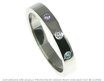 Platinum wedding band incorporating an invisibly set 1.5mm brilliant cut amethyst, 1.5mm brilliant cut H Si diamond 0.015ct and a 1.5mm london blue topaz.