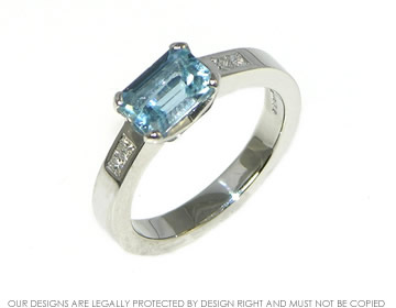 Engagement ring with an emerald cut Aquamarine with diamonds. 