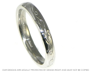 Bespoke platinum ladies wedding ring with engraved ivy detail. 