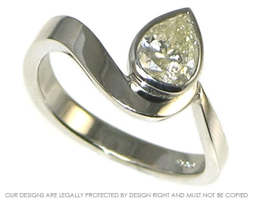 Platinum engagement ring with a pear shaped diamond inspired by the ocean. 