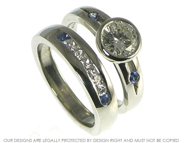 Bespoke platinum engagment and wedding ring set with diamonds and sapphires.